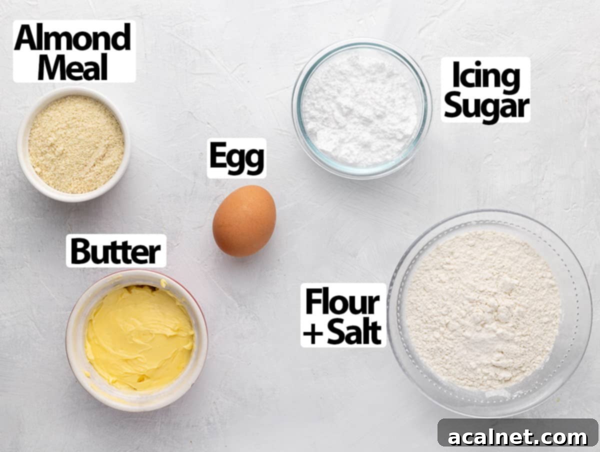 Ingredients for Pâte Sucrée: Butter, Icing Sugar, Egg, Almond Meal, Flour, and Salt arranged on a white surface.
