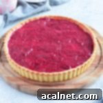 Tart on a wooden board with grey napkin