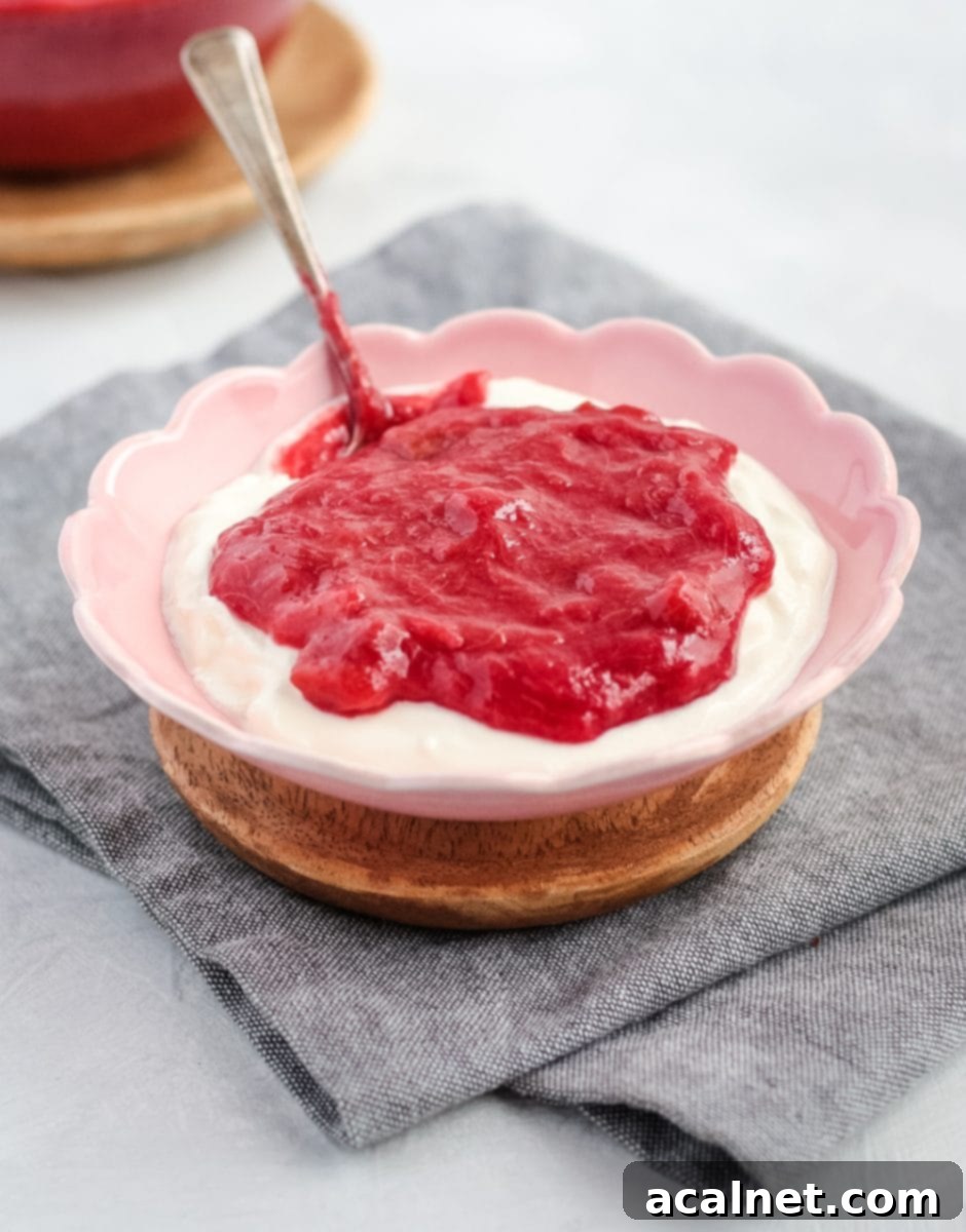 Rhubarb over greek yogurt in a bowl with a spoon