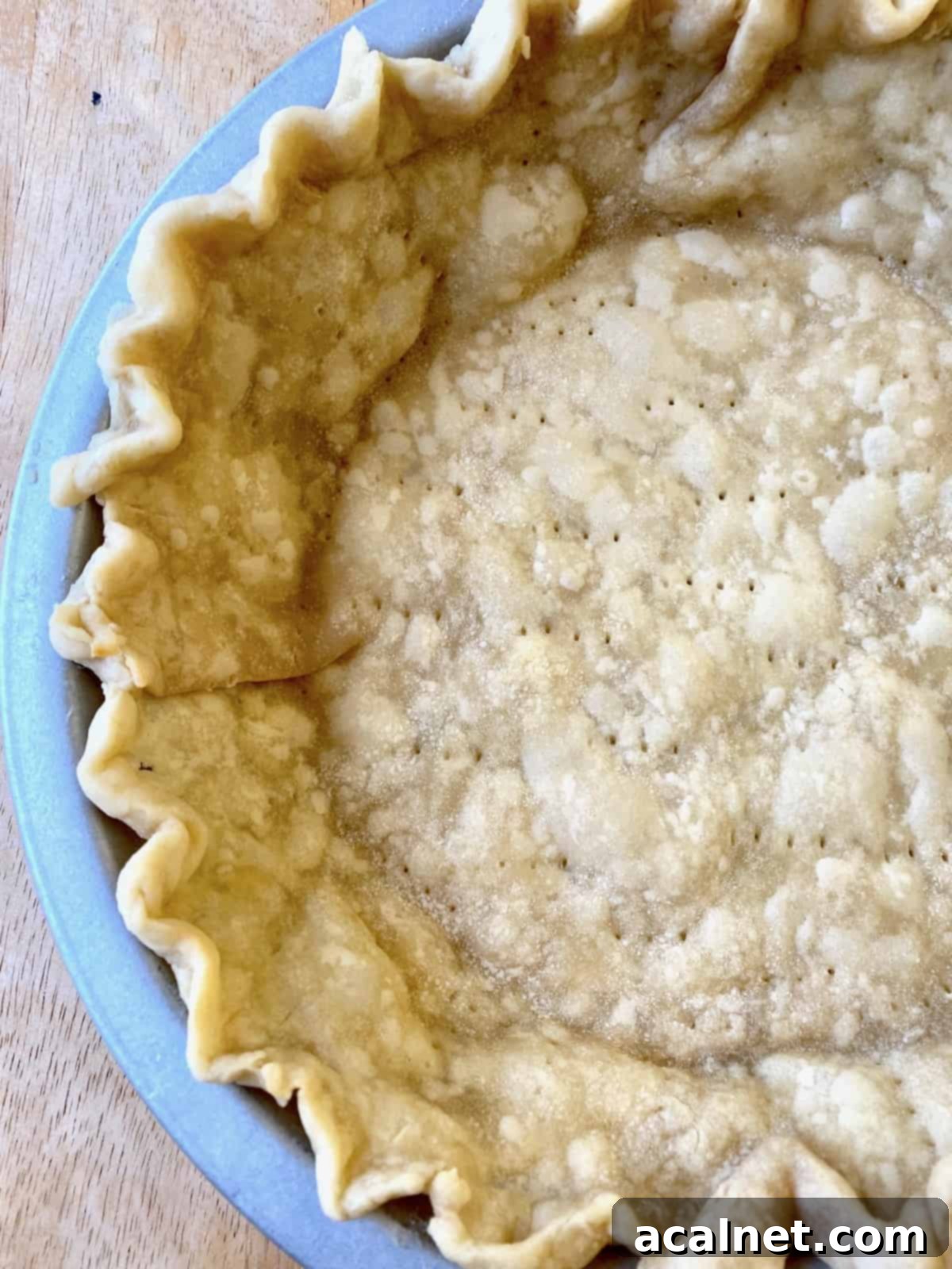 A golden-brown baked pie crust in a pie dish, ready for filling.