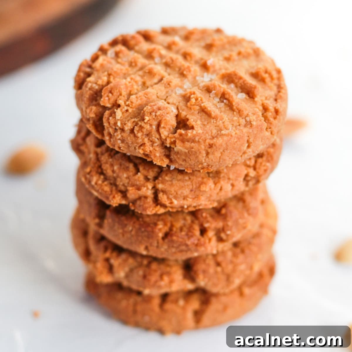 Stack of 4 cookies on a white surface.