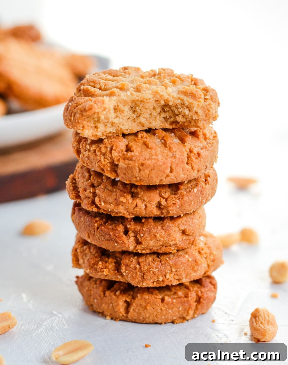 Stack of cookies with a bite taken off the top cookie.