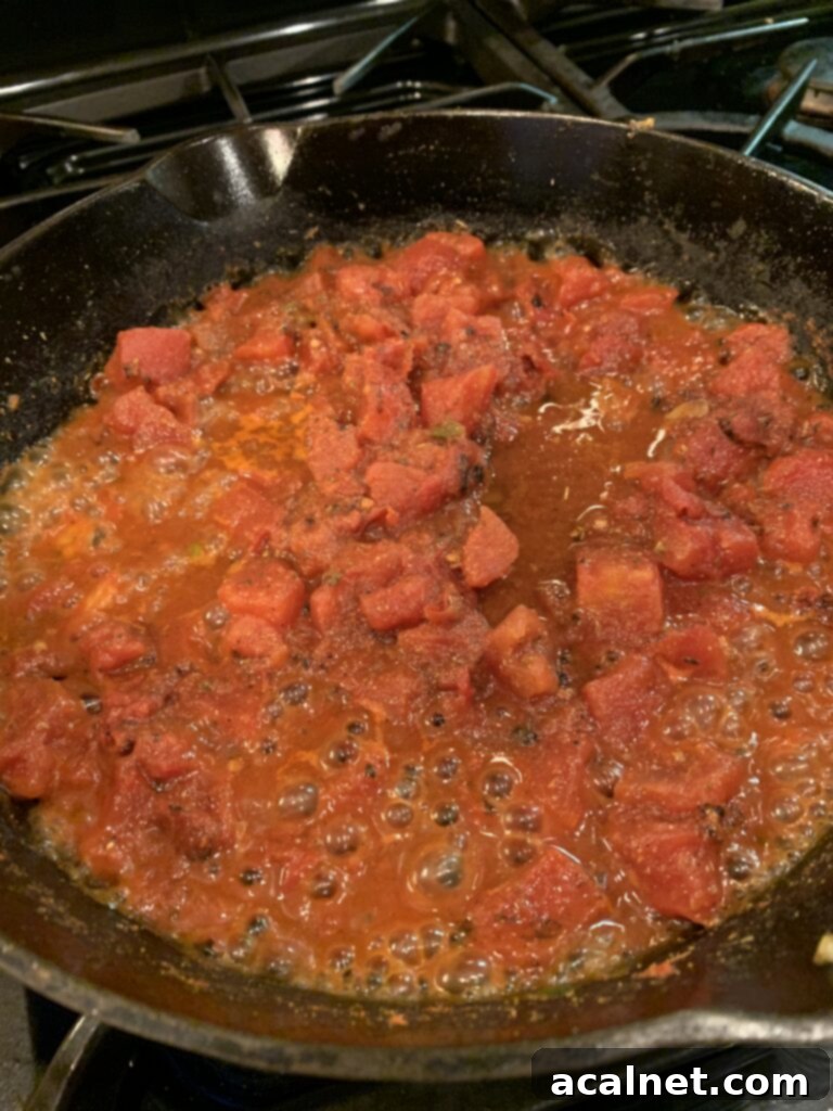 Tomato sauce simmering in a skillet. 
