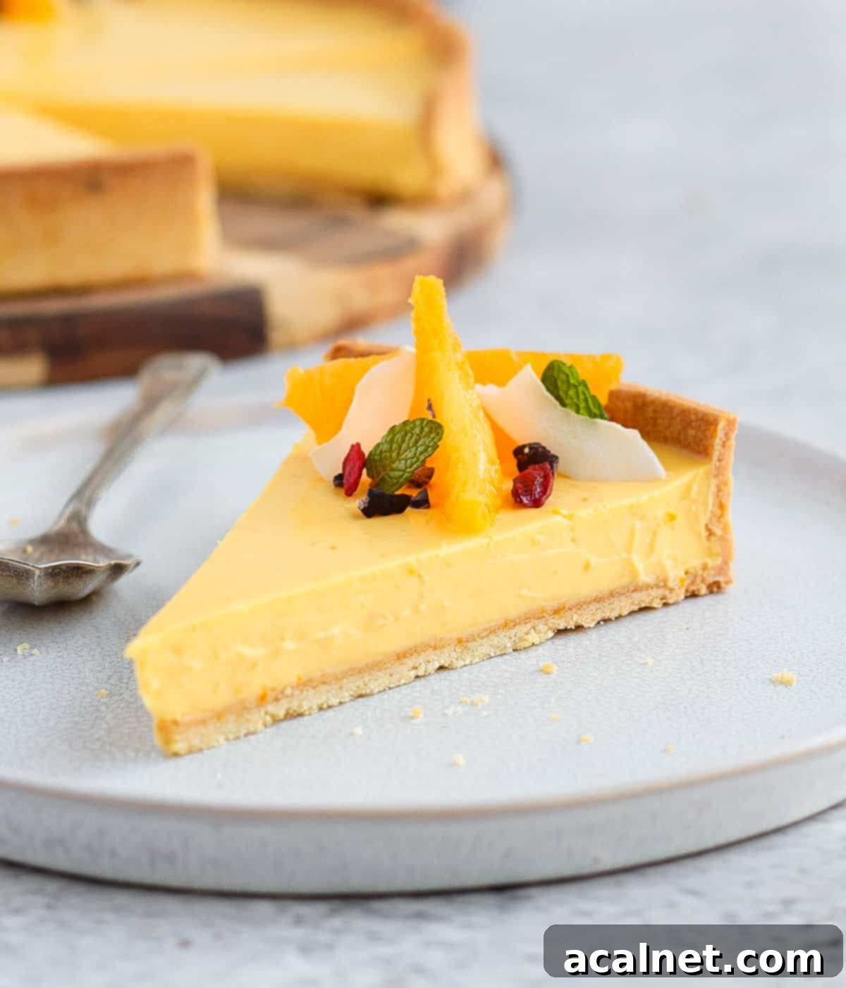 One slice over a small white plate with a silver spoon.