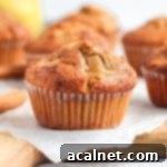 Warm Spiced Pear Muffins 10 Close up on a muffin over baking paper and a wooden board
