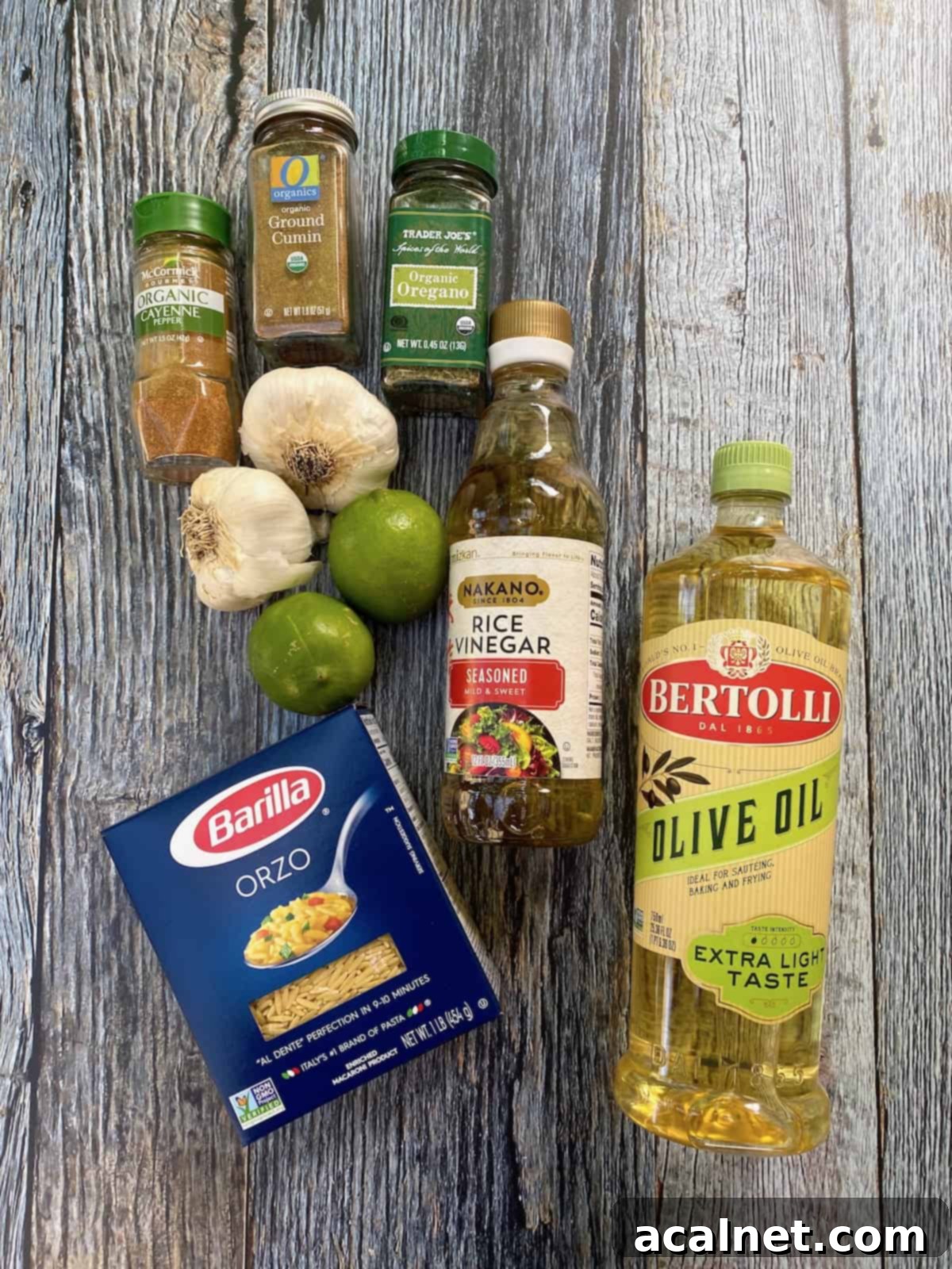 Salad dressing ingredients including a box of pasta, spices and olive oil and vinegar for sweet corn pasta salad.