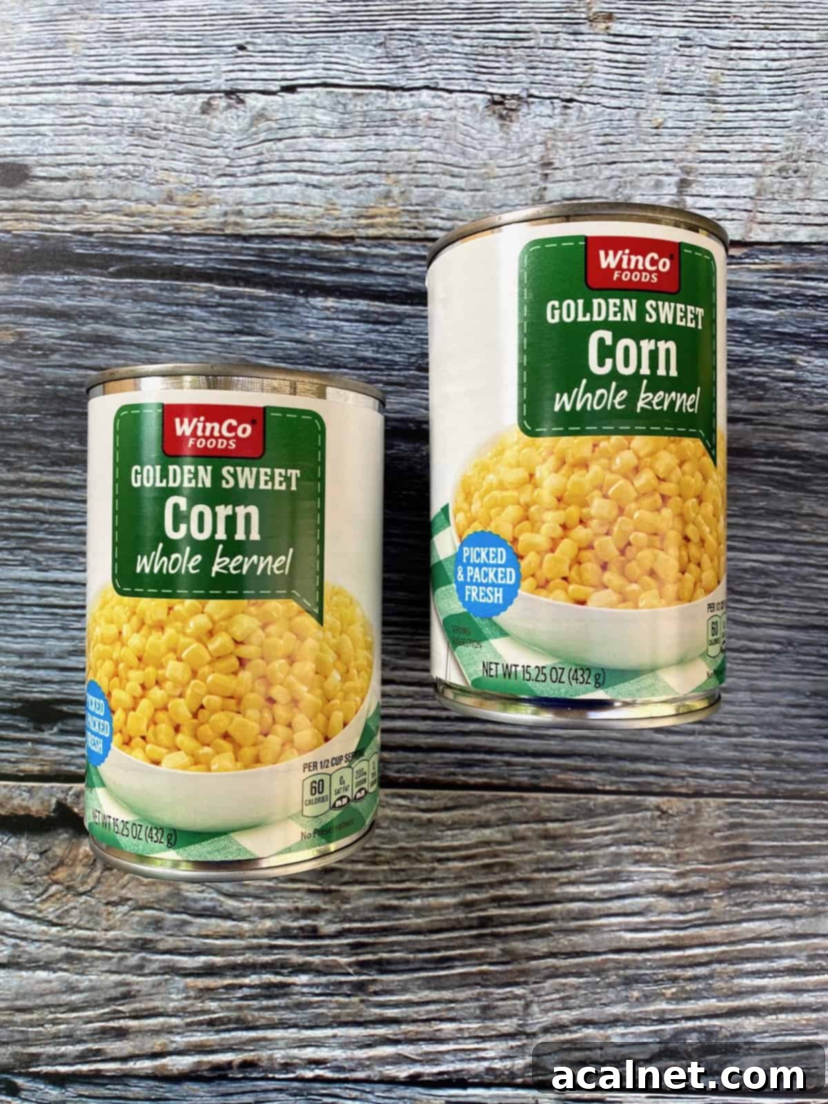 Two cans of whole kernel corn. 