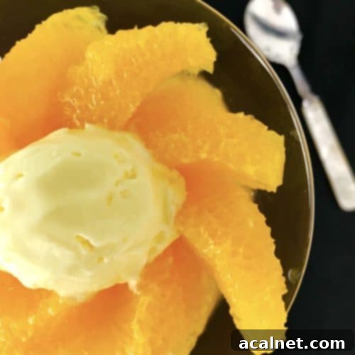 Plates of elegant Brandied Oranges, glistening with syrup and ready to be served.
