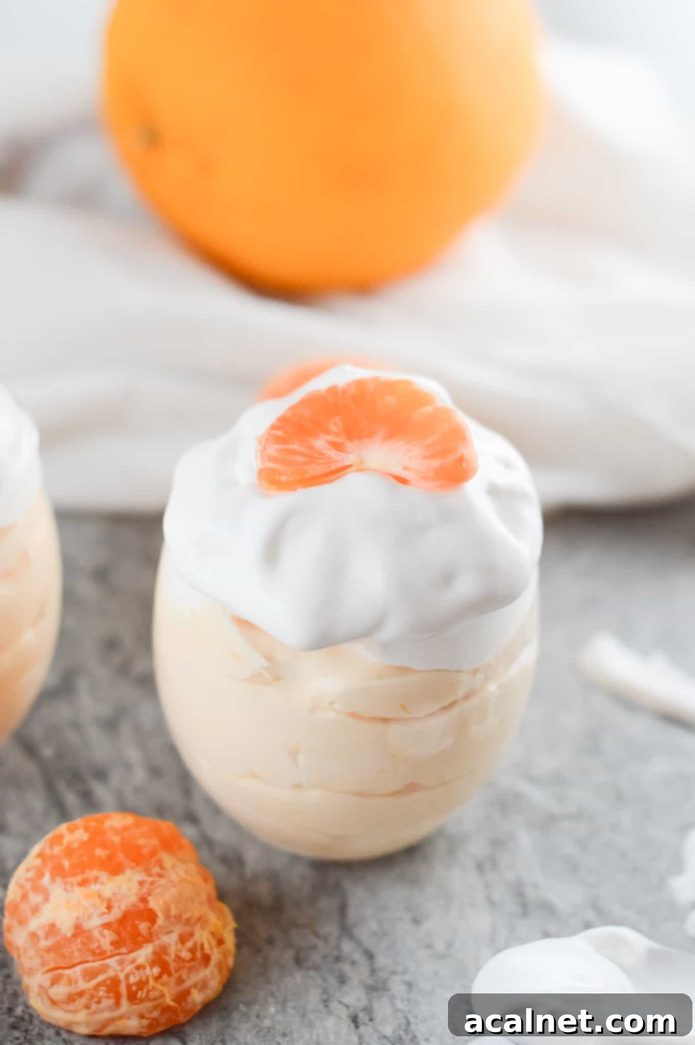 Individual Orange Mousse Cups, light, fluffy, and garnished with fresh orange zest.