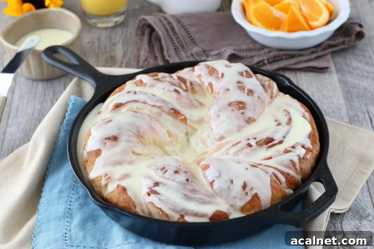 A beautifully braided Orange Cardamom Breakfast Bread Twist, golden brown and glistening.