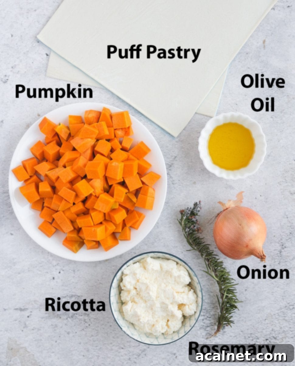A flat lay of fresh ingredients for pumpkin tart: pumpkin, ricotta, onion, rosemary, puff pastry