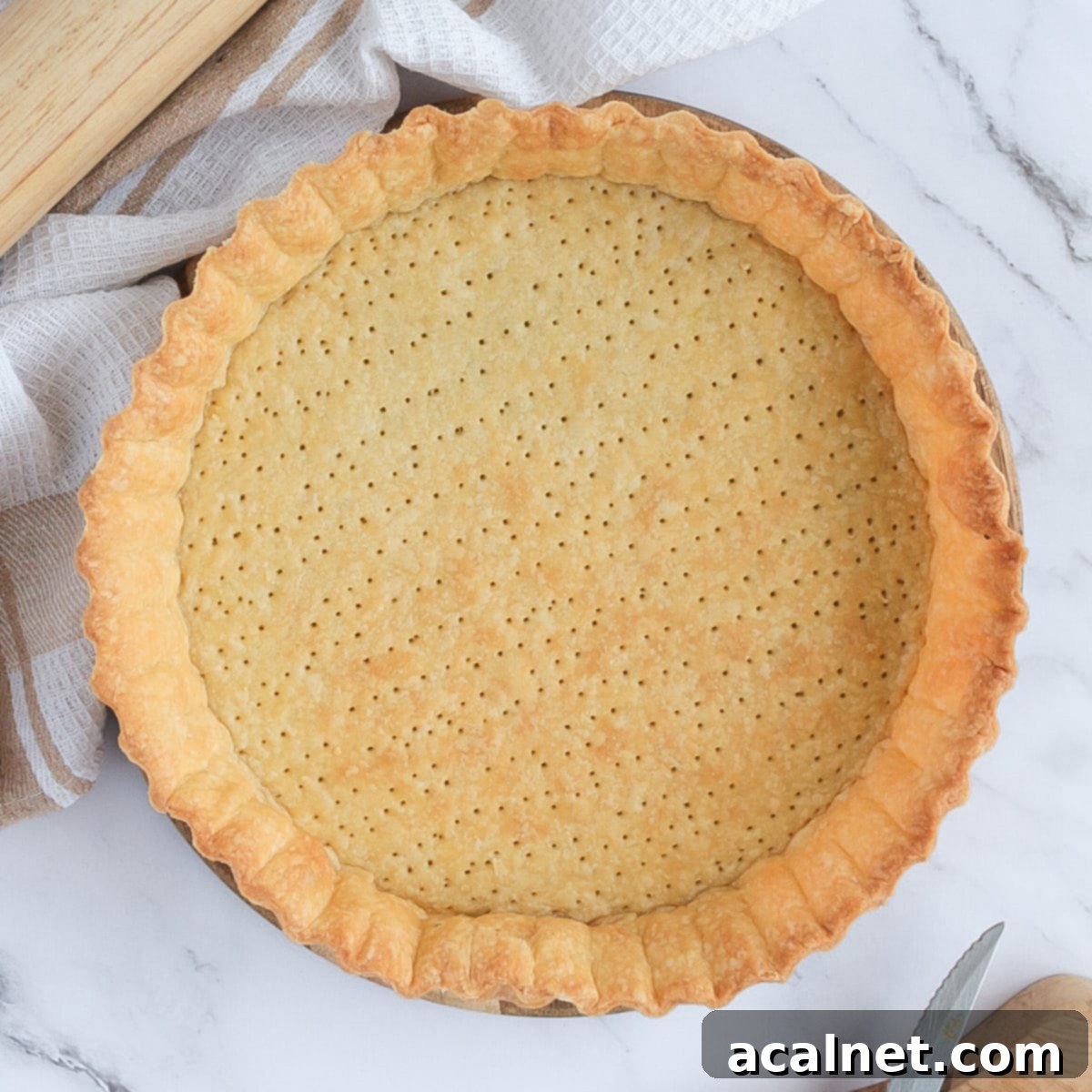 Blind-baked pastry from above on a marble surface