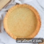 Blind-baked pastry from above on a marble surface