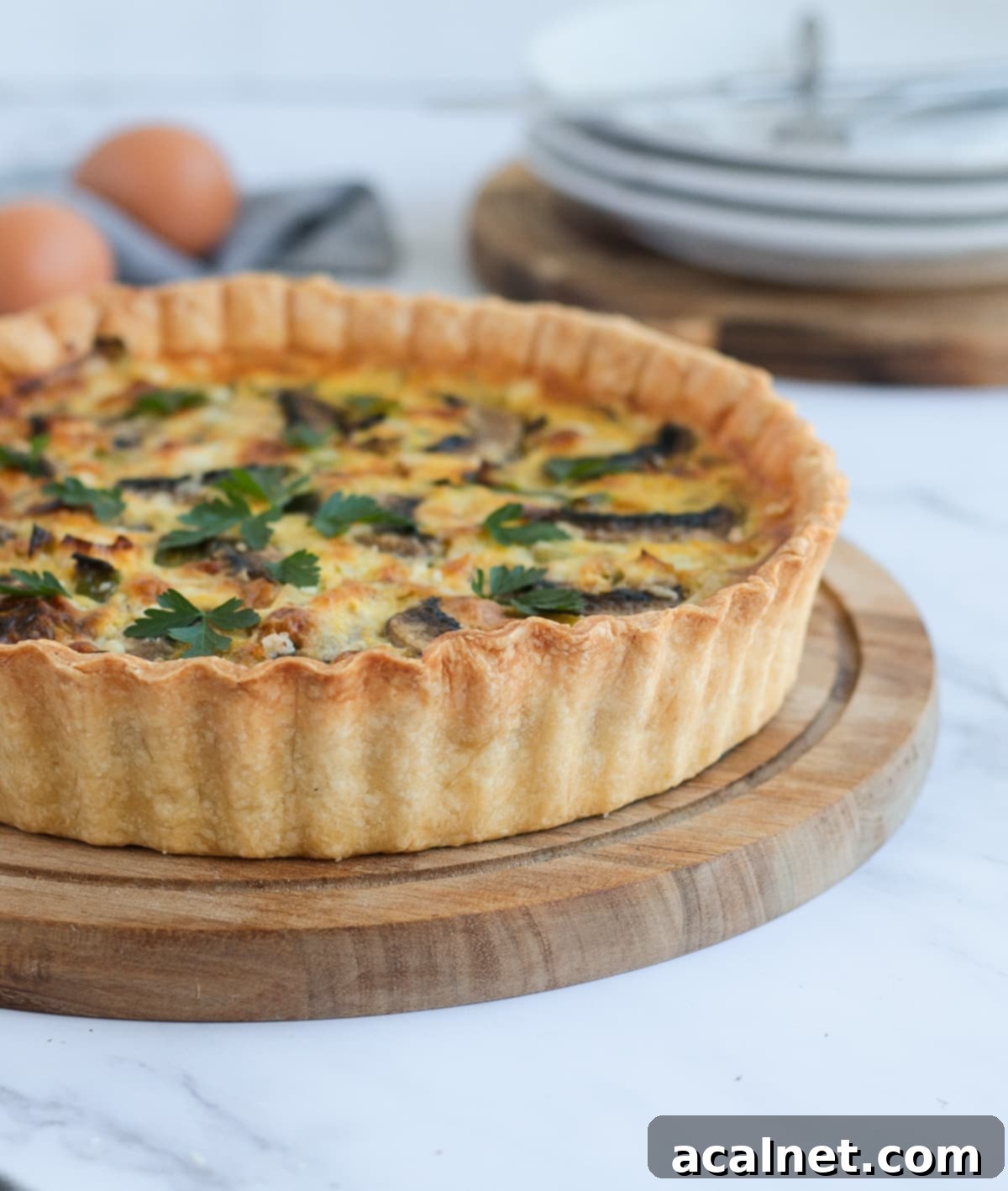 Side view on a quiche over a wooden board