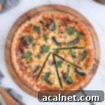 Flatlay photo of the quiche on a round board with 3 slices cut off, emphasizing its appealing presentation.