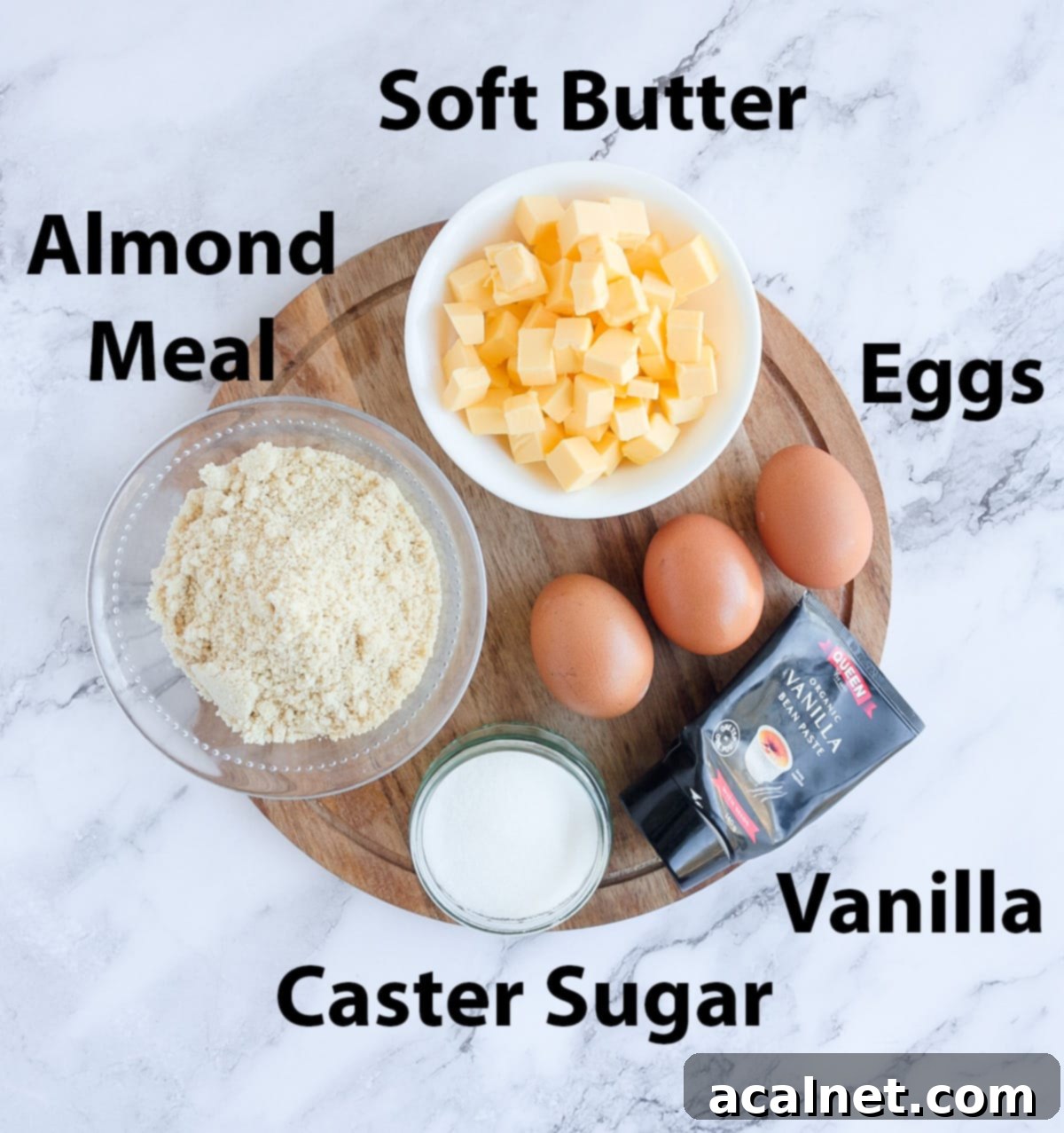 Almond Cream Filling Ingredient Shot. A close-up arrangement of the simple ingredients needed for frangipane: soft butter, caster sugar, an egg, and almond meal, with a hint of vanilla paste, ready for mixing.