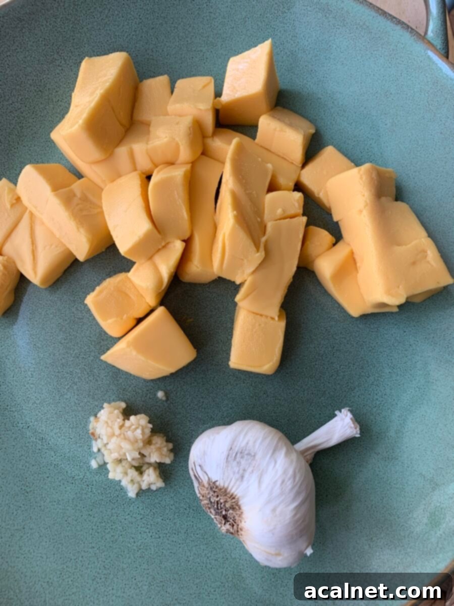 Cubed cheese and garlic on a plate.