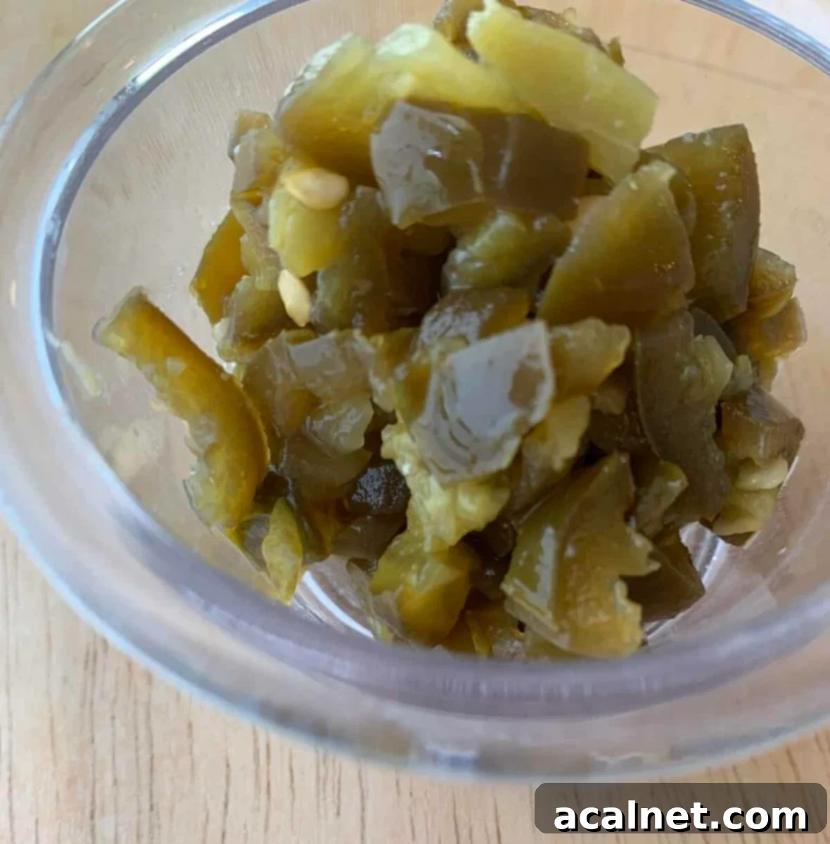 Diced jalapeno peppers in a small bowl.