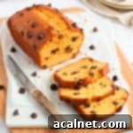 Loaf on a white stone board with 3 slices cut