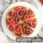 Flatlay photo of the cake on a round white board with 4 slices cut off.