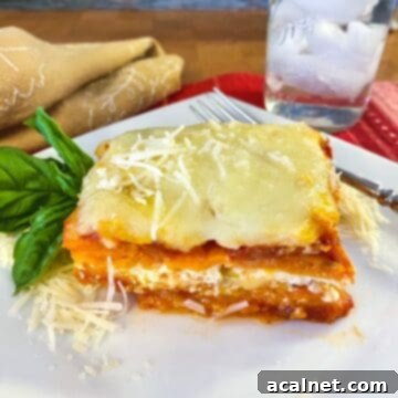 Sweet Potato Lasagna Perfection 18 A serving of sweet potato lasagna on a plate with a glass of water off to the side.