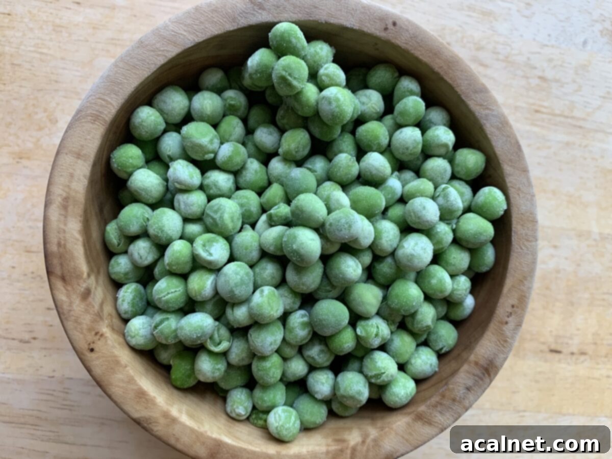 Frozen peas in a small bowl, ready to be added to pasta