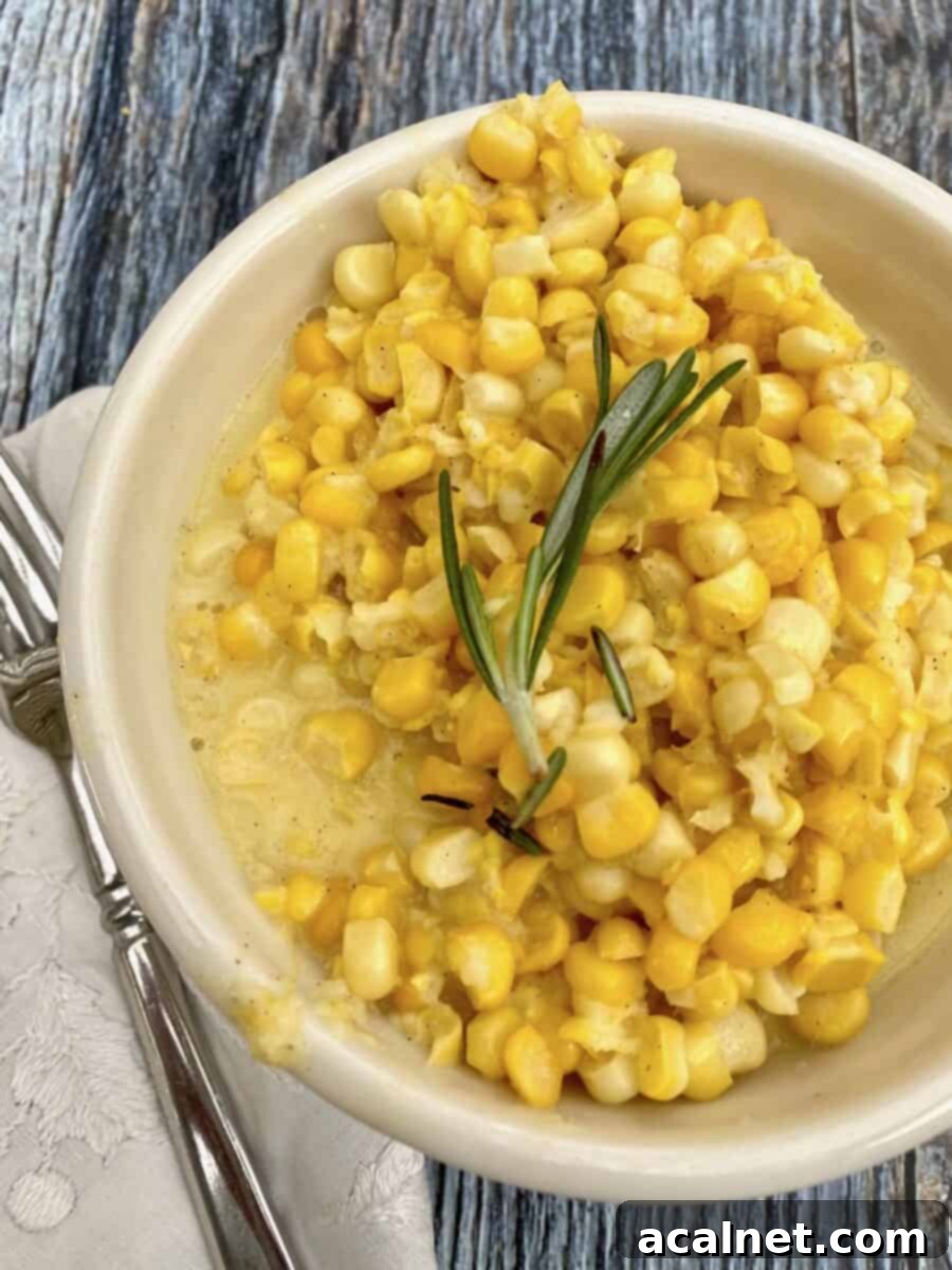 Creamed corn in a small bowl with a fork and napkin on the side. 