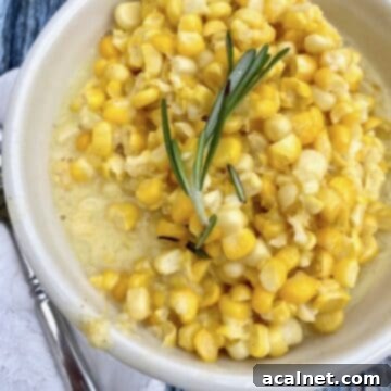 A small bowl of creamed corn with a knife on the side.