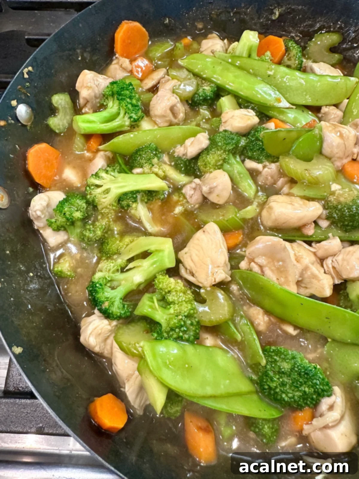 Chicken and Cashew Stir-Fry 11 Veggies for cashew chicken stir fry with chicken in a pan.