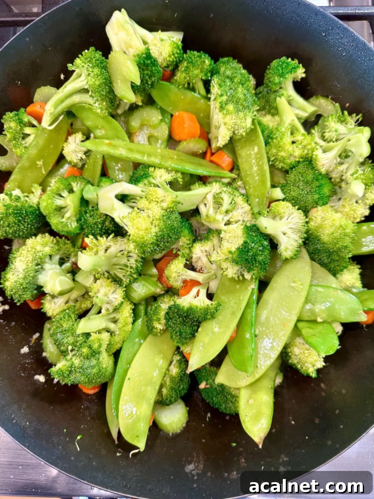 Chicken and Cashew Stir-Fry 8 Cooked vegetables in a pan.