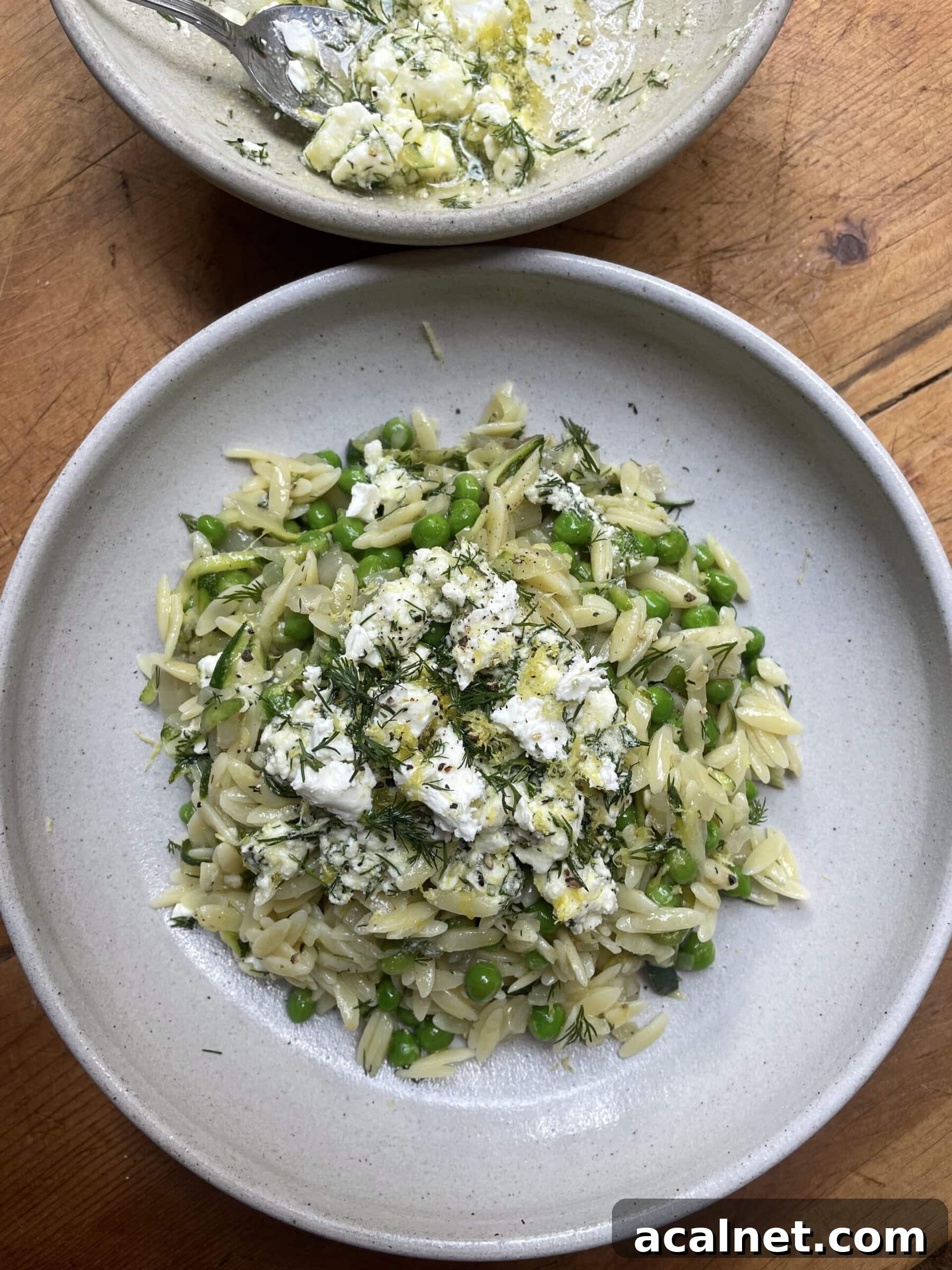 lemon orzo with feta in a grey bowl.