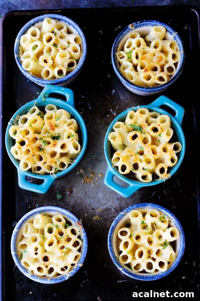 Cheesy Pasta Bake in Individual ramekins on a sheet pan