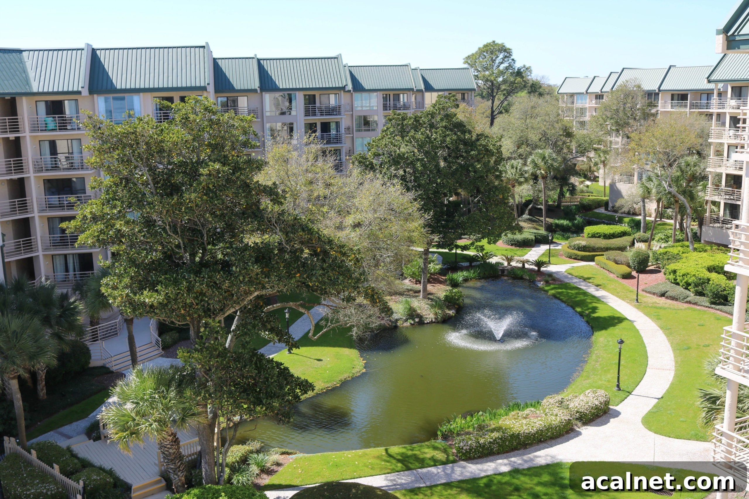 Caprese Grilled Fish Condo Shot Watermarked Pond, trees and walkways of interior courtyard at Villamare condos in Hilton Head.