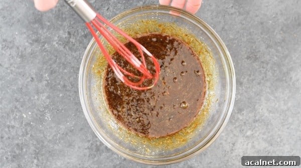 The wet ingredients with molasses mixed in a bowl.