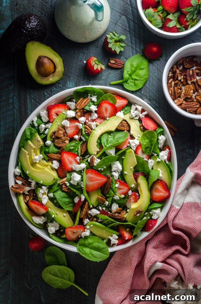Strawberry Avocado Spinach Salad with Greek Yogurt Poppy Seed Dressing. This simple salad is full of creamy, crunchy, nutty, fruity, tangy, and summer-friendly flavors. You're gonna love it! | hostthetoast.com