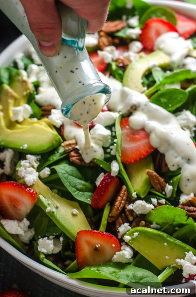 Strawberry Avocado Spinach Salad with Greek Yogurt Poppy Seed Dressing. This simple salad is full of creamy, crunchy, nutty, fruity, tangy, and summer-friendly flavors. You're gonna love it! | hostthetoast.com