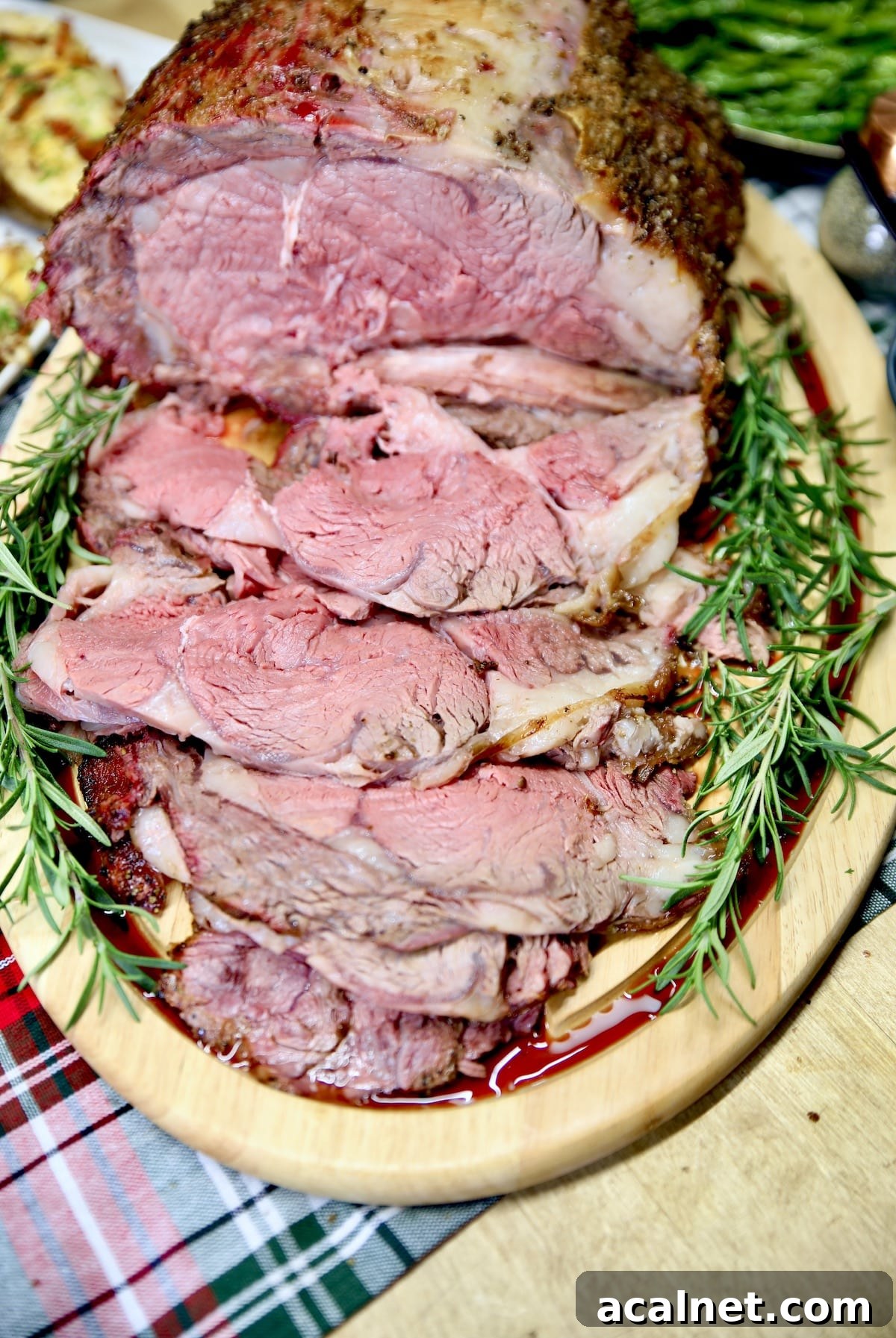 Christmas prime rib roast. Easy holiday dinner prepared on the grill. Sliced prime rib roast on a cutting board.