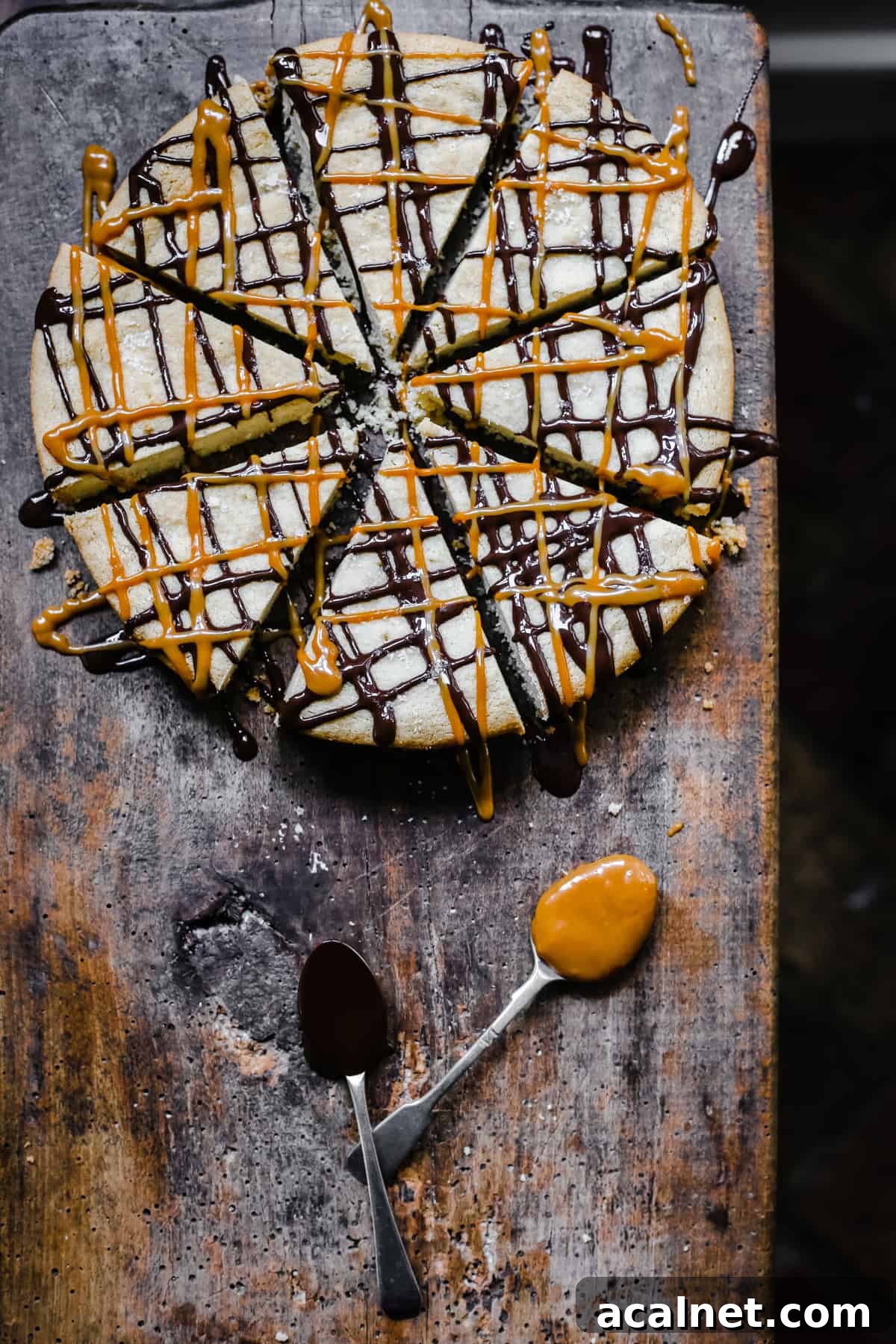 Gluten-free shortbread drizzled with chocolate and dulce de leche on wooden board