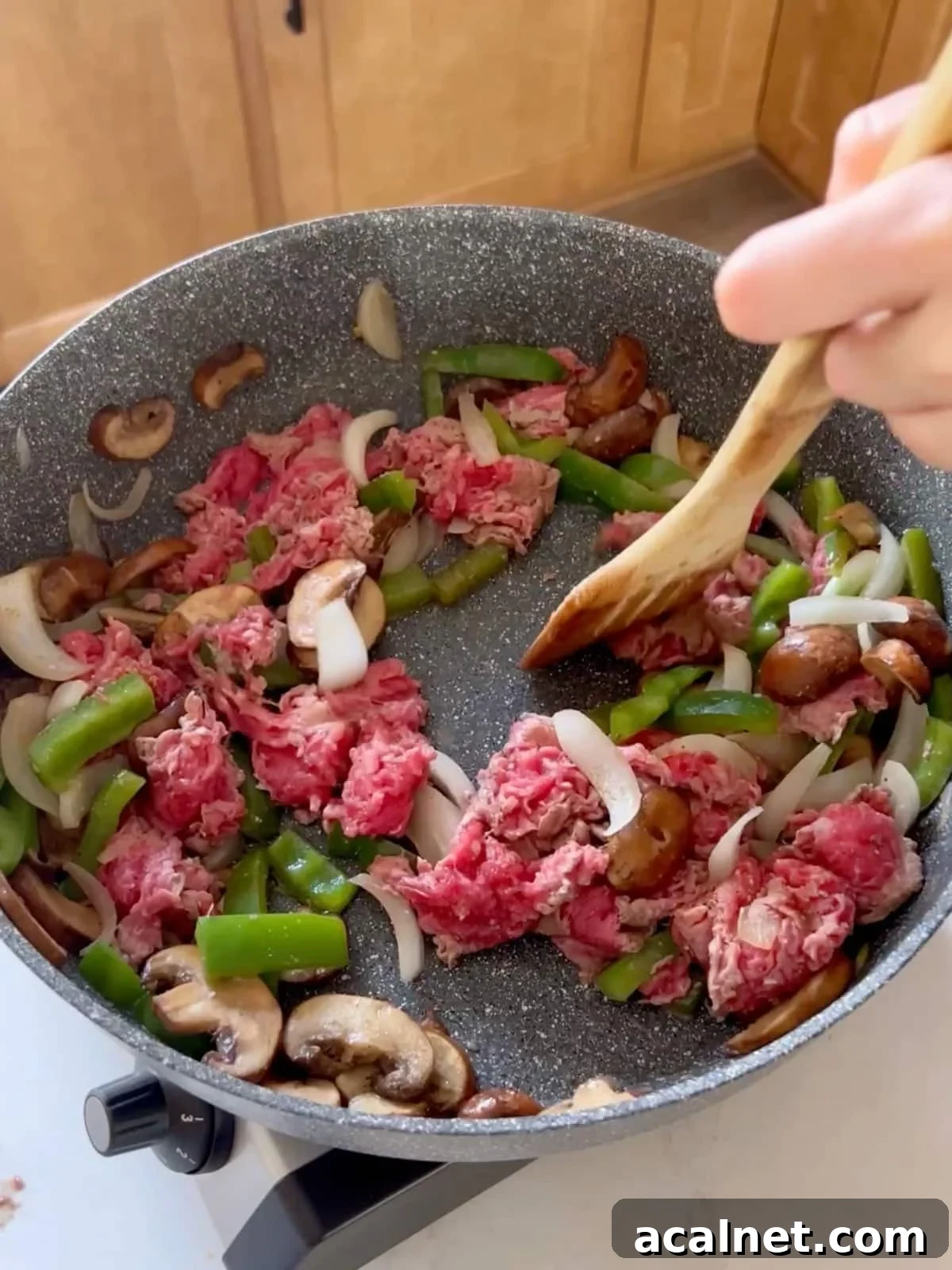 Meat added to the vegetables in the sauté pan cooking.