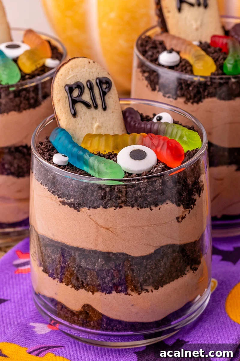 Best Oreo dirt dessert cups on Halloween napkins on table.