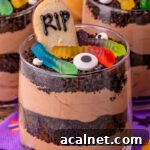 Best Oreo dirt dessert cups on Halloween napkins on table.