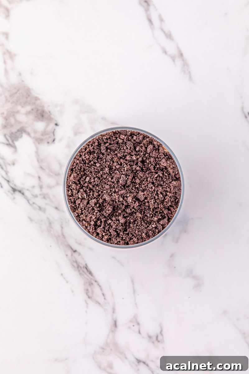 Crushed oreo cookies in bowl.