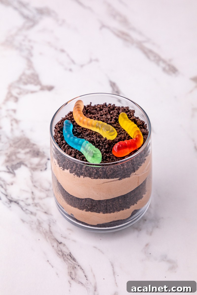 Gummy worms are sprinkled on top of the dirt cup as garnish.