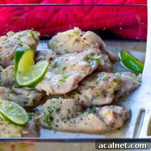 honey lime chicken in a glass casserole dish with carrots and rice in the background