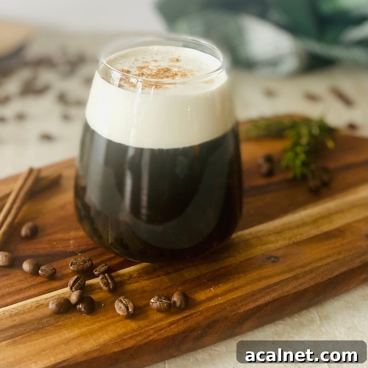 How to Make Sweet Cream Cold Foam for Coffee Drinks 7 Sweet Cream Cold Foam Recipe next to coffee beans.
