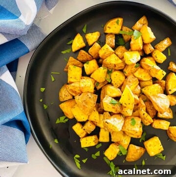 air fryer diced potatoes on a plate with parsley garnish