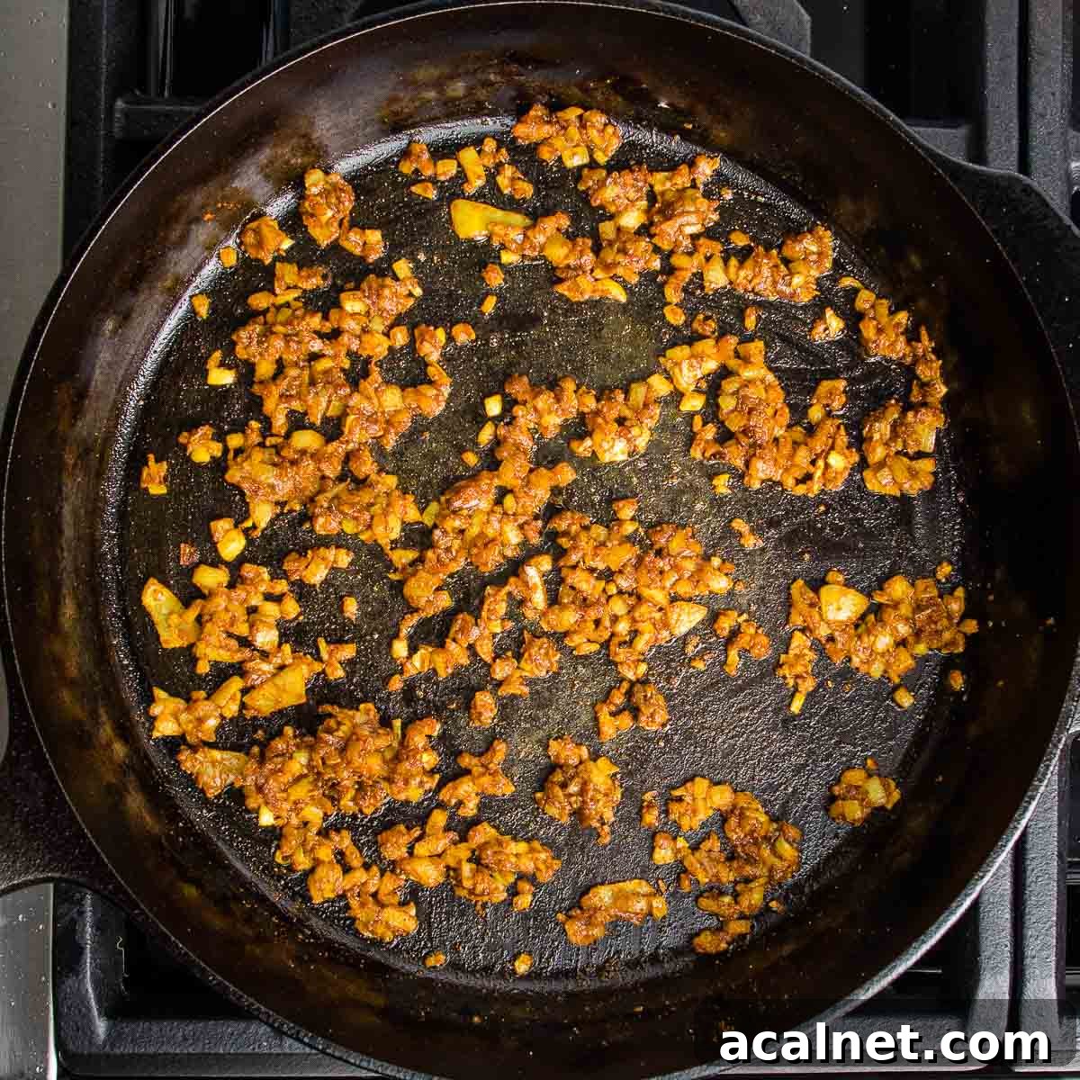Onions, garlic and spices sauteed in a cast iron skillet