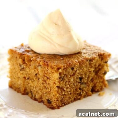 a slice of pumpkin walnut cake topped with homemade caramel whipped cream