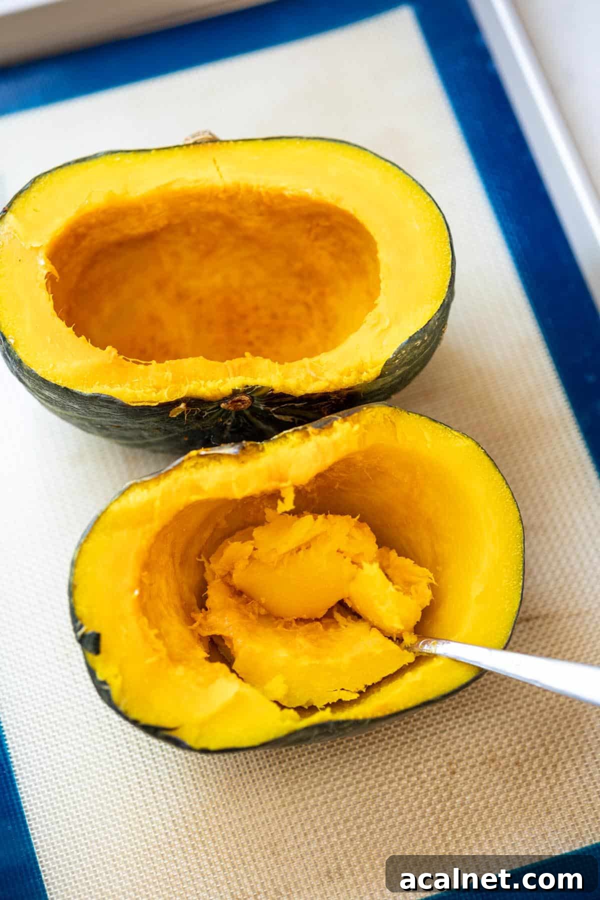 Scooping out the flesh from a roasted pumpkin.