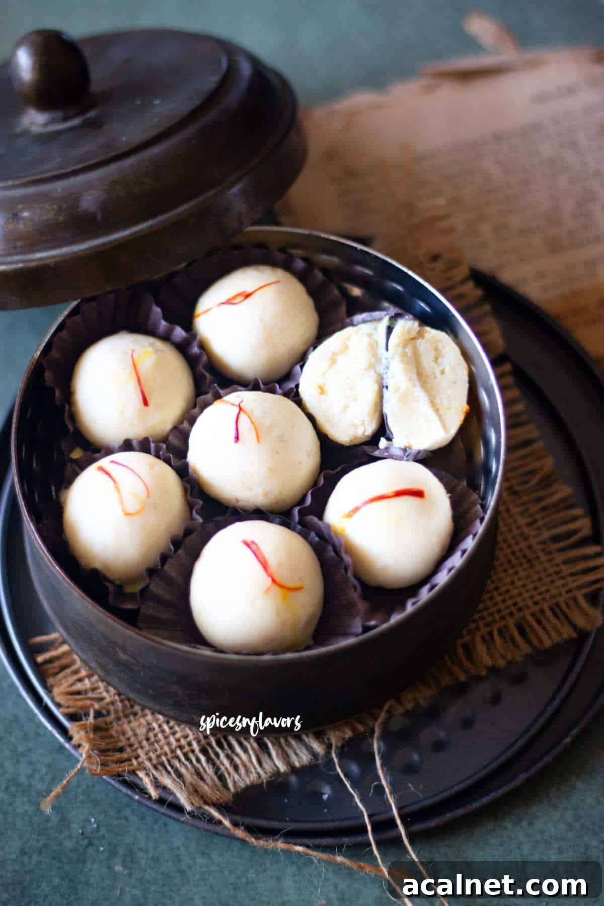 Malai Ladoo sliced into two to show the texture from within